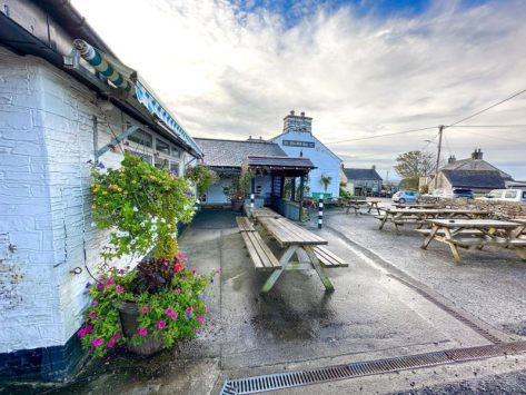 Pub garden with benches outside The Old Inn, St Breward on Bodmin Moor, Cornwall.