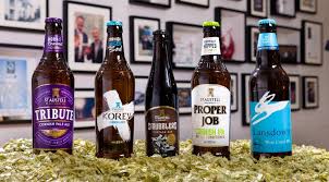Bottles of St Austell Brewery beers including Tribute Ale, Proper Job IPA, and Korev Lager.