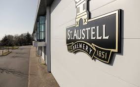 St Austell Brewery logo displayed on the side of the brewery building in Cornwall.