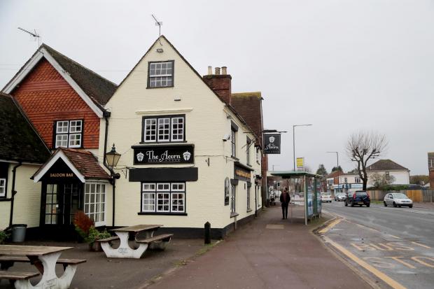 Front view of The Acorn pub in Kinson, Bournemouth, known for ghost stories involving a mysterious figure counting gold coins