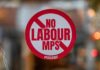 Has the Government Destroyed Britain’s Pubs? No Labour MPs Allowed sign displayed in the window of a UK hair salon protesting rising business rates and government policies affecting small businesses.