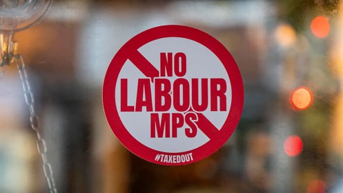 No Labour MPs Allowed sign displayed in the window of a UK hair salon protesting rising business rates and government policies affecting small businesses.