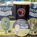 Peculier Assassin collaboration beer from Theakston and Rooster’s Brewing Co displayed in can, pint glass and pump clip format.