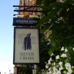 Silver Cross pub sign on Whitehall in London featuring King Charles II and a King Charles Spaniel outside the historic Westminster pub.