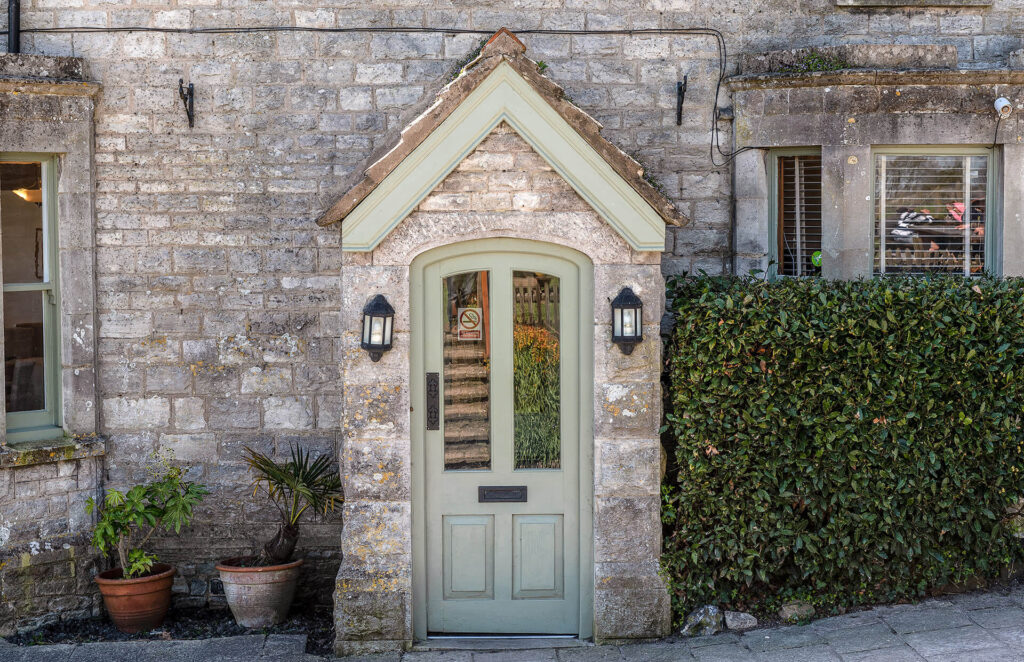Historic stone doorway and framed pictures inside the inn